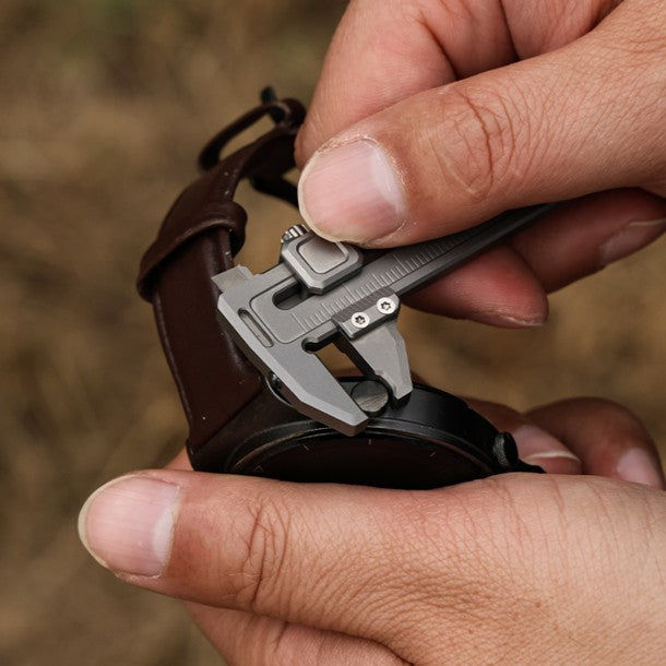 Compact titanium caliper measuring wristwatch lug width, precise multi-function EDC tool for everyday use.