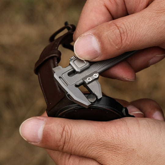 Compact titanium caliper measuring wristwatch lug width, precise multi-function EDC tool for everyday use.