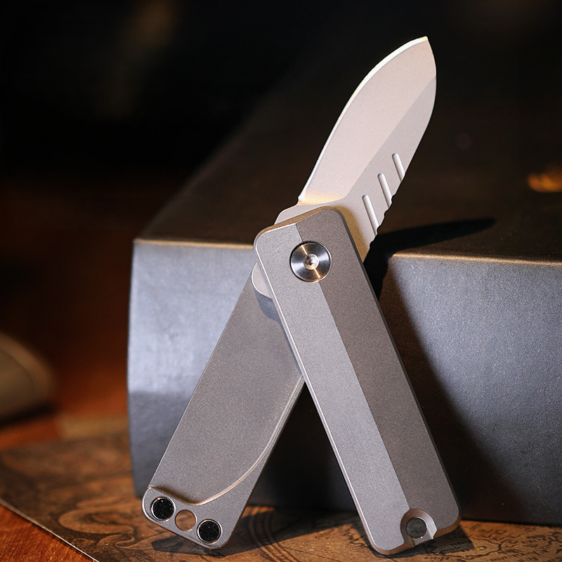 TiSpin Blade titanium magnetic fidget utility knife close-up showing compact EDC titanium body