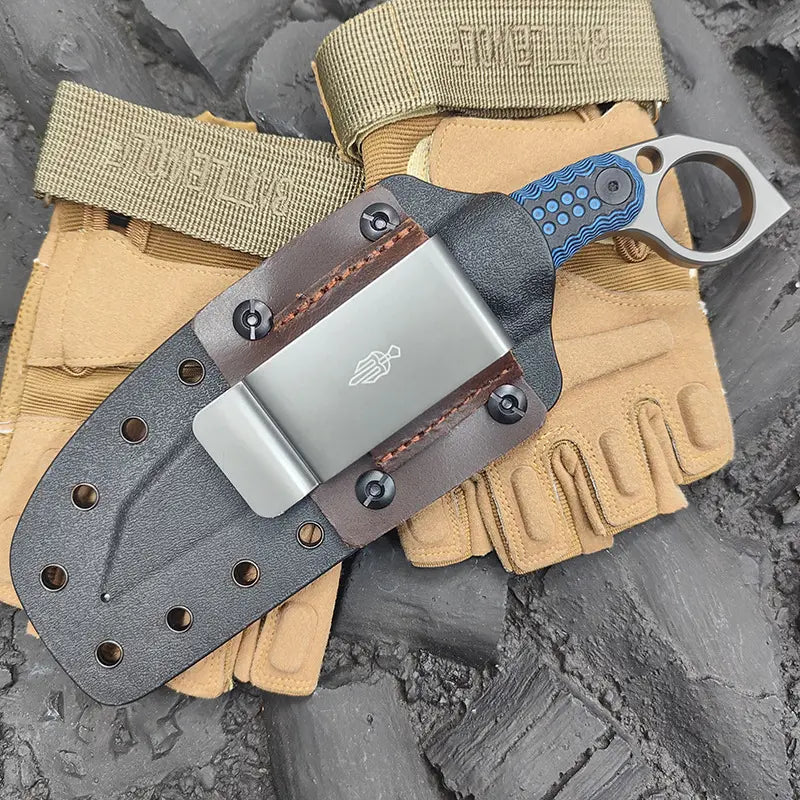 Claw forge tactical edc knife with leather sheath on a tactical pouch against a textured background